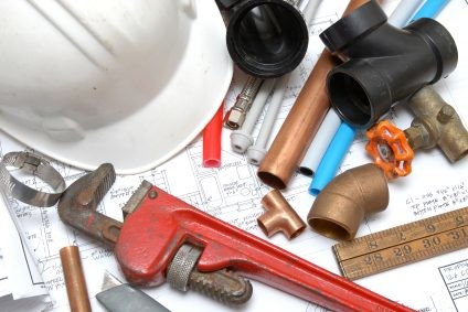 Plumbing parts, tools, and plans used by Kevin Ginnings Plumbing Service Inc..